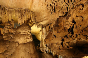 Stalagtites and stalagmites are shown reaching from the ceiling to the floor, from the floor to the ceiling in Crystal Cave at Sequoia National Park
