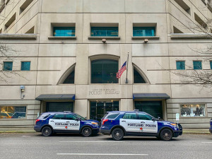 Two Portlnd Police cars in front of Portland Bureau central precinct