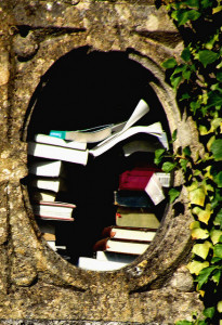 Books stacked in round concrete window