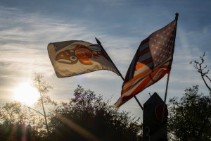 Tony Johnson and Rachel Cushman from the Chinook Indian Nation two native flags flowing in the wind