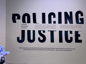 POLICING JUSTICE logo including names of artists and curators and a statement of purpose