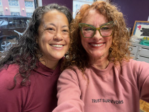 two women smile at camera