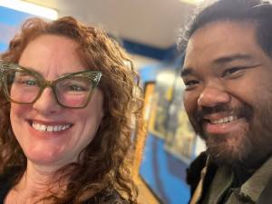 Lisa Loving and Paul Susi smiling in the KBOO lobby