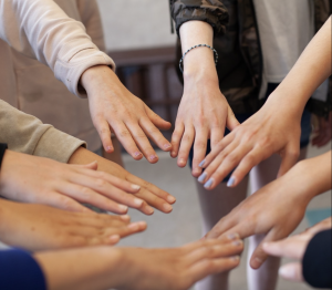 Rose City Self Defense Fall Classes girls hands held towards each other in a circle, like spokes on a wheel