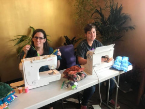 Positive Charge Members sewing therapeutic blankets Positive Charge Members sewing therapeutic blankets