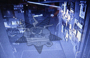 The Self Help Radio logo in a security camera television feed - but the logo is upside down!